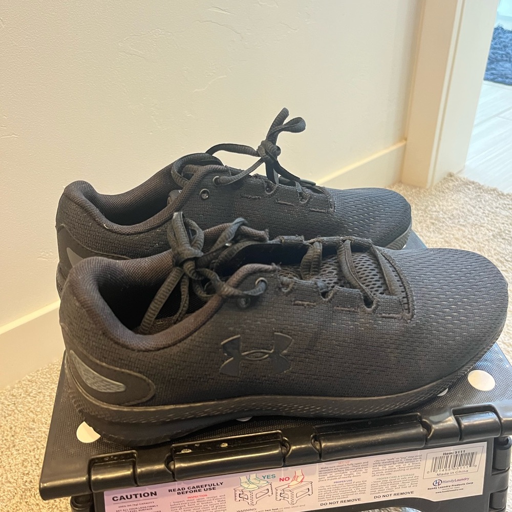 All black UA tennis shoes